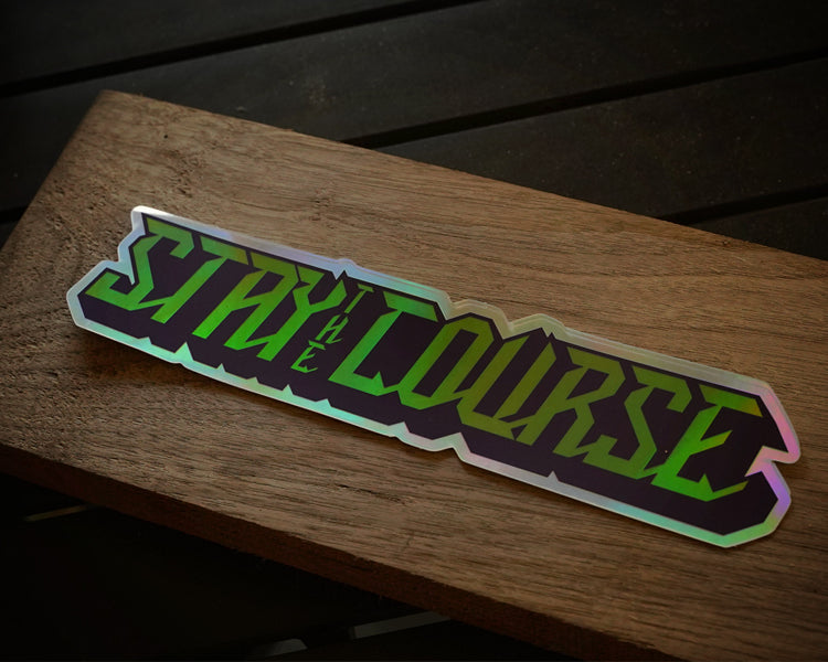 Holographic 'Stay the Course' sticker on a wooden surface