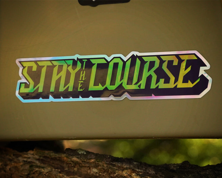 Sticker with 'Stay the Course' text on a beige surface