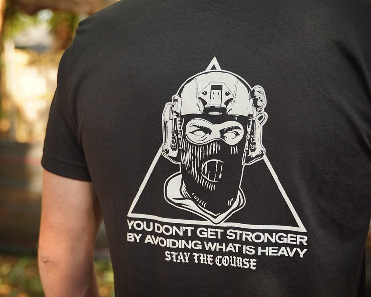 Black t-shirt with white graphic and text on the back, worn by a person.