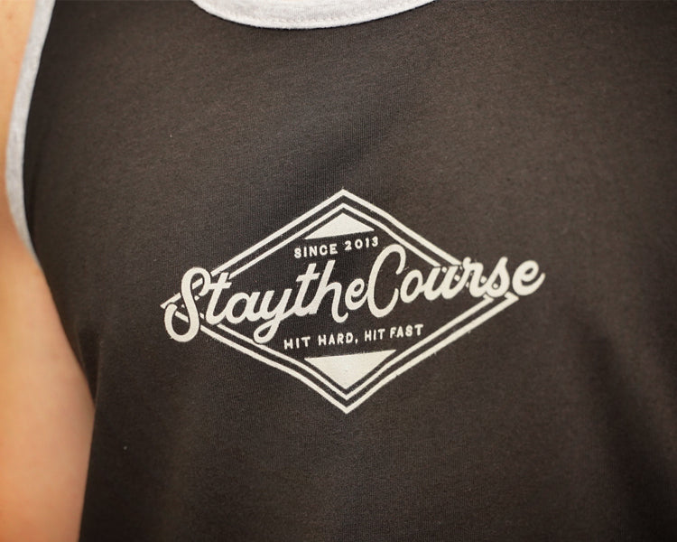 Black tank top with 'Stay the Course' logo on a blurred background