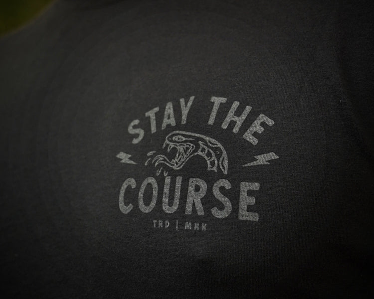 Text 'Stay the Course' on a black t-shirt