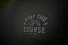 Text 'Stay the Course' on a black t-shirt