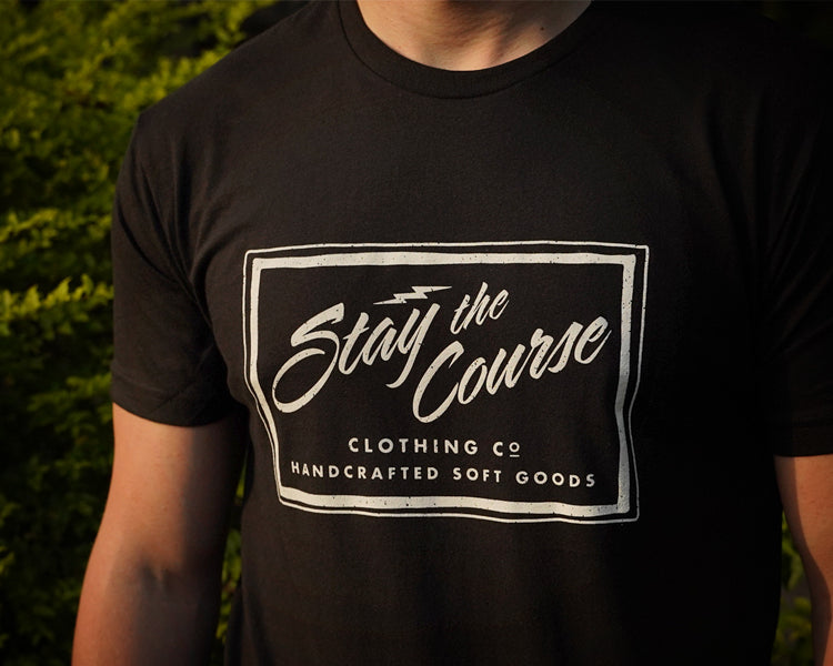Person wearing a black t-shirt with 'Stay the Course Clothing Co' logo.