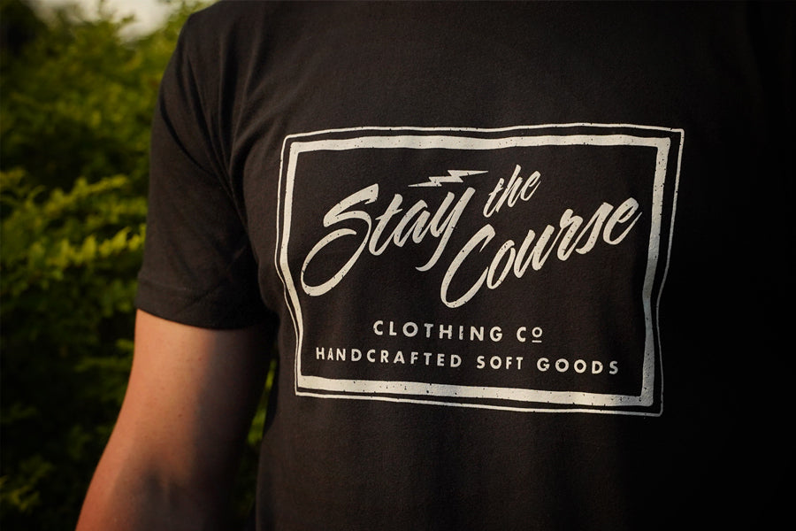 Black t-shirt with 'Stay the Course' clothing co logo