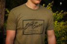 Person wearing a green t-shirt with 'Stay the Course Clothing Co' logo.