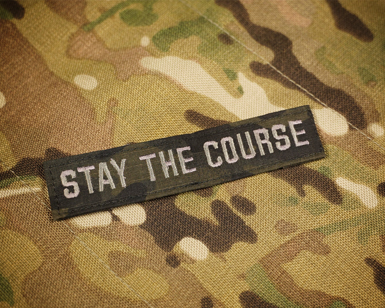 Black camouflage patch reading 'Stay the Course'