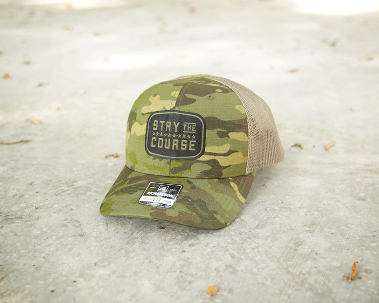 Camouflage cap with text on concrete