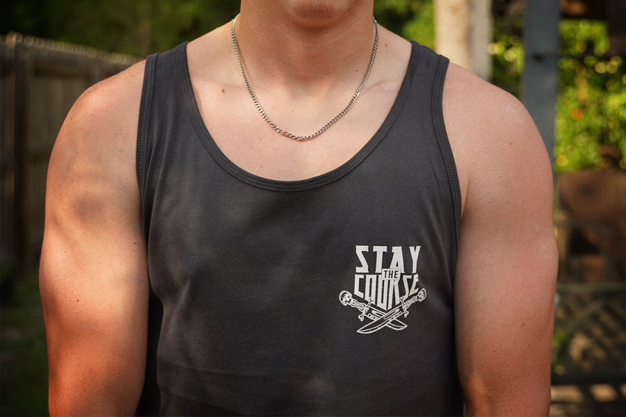 Person wearing a black tank top with 'Stay the Course' text and logo.