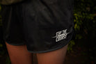 Black shorts with 'Stay the Course' text on a dark background