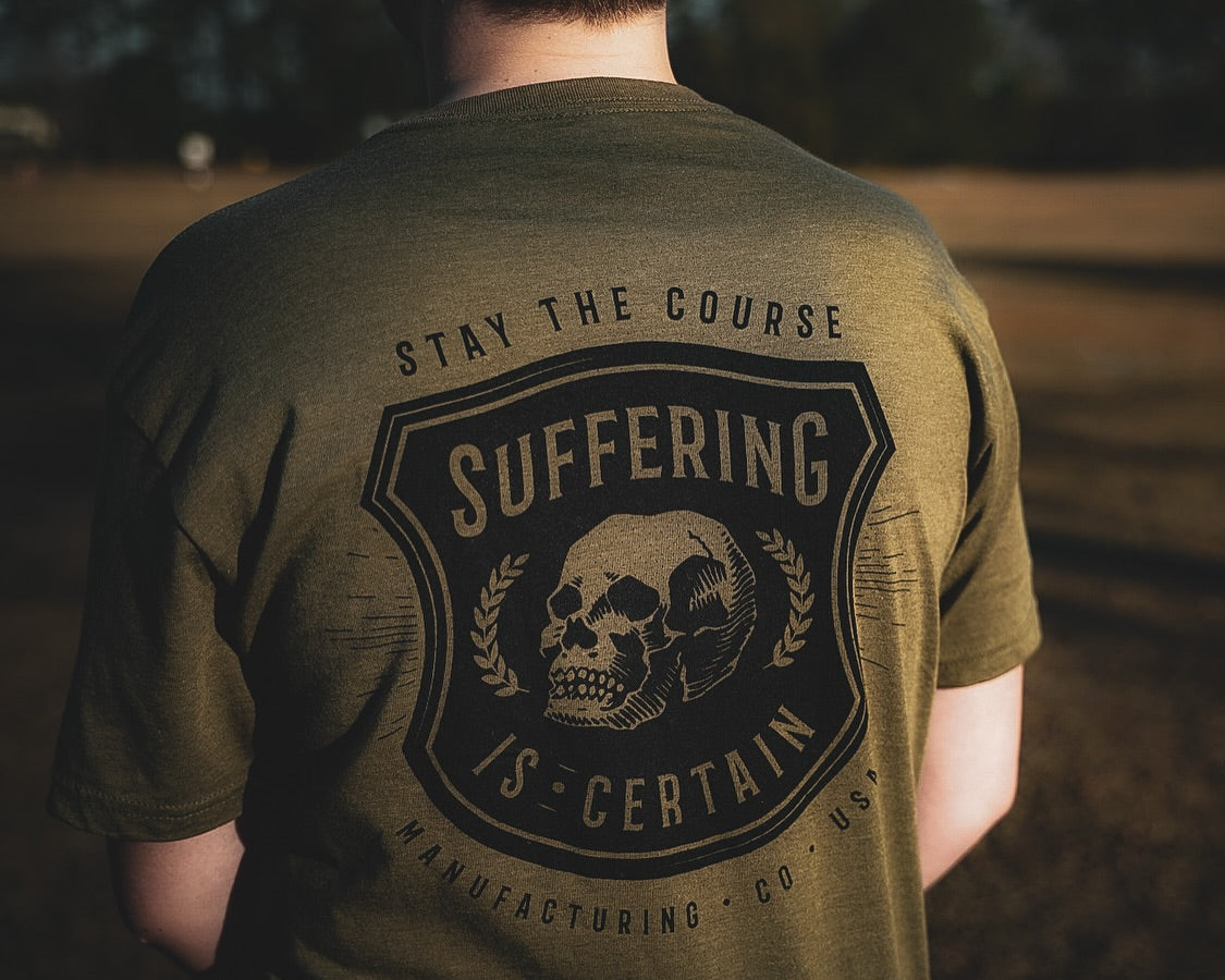 Person wearing a green t-shirt with a skull design and text in an outdoor setting