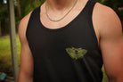 Person wearing a black tank top with a green moth design outdoors