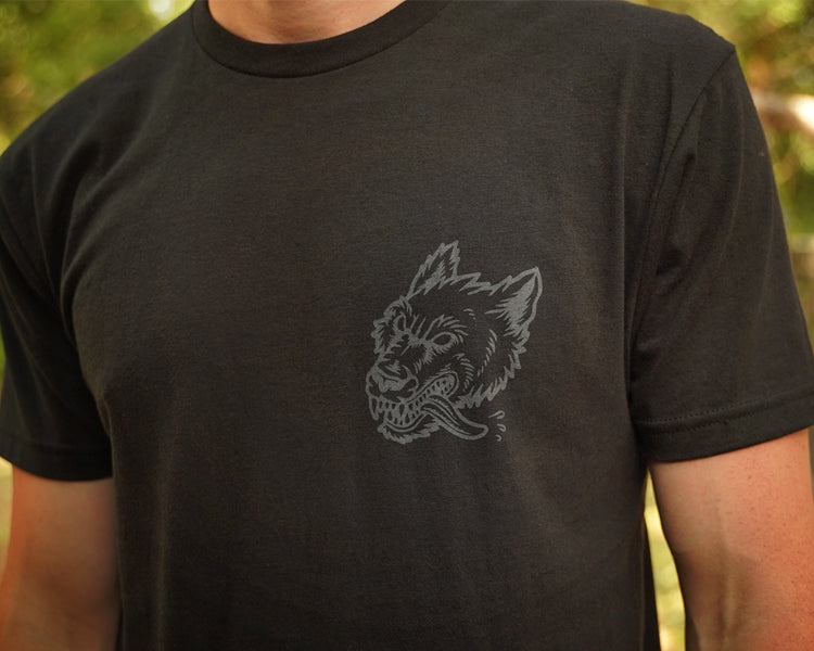 Person wearing a black t-shirt with gray print of wolfhound head