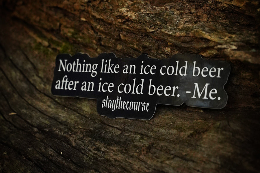 Sticker with humorous quote about ice cold beer on a wooden background
