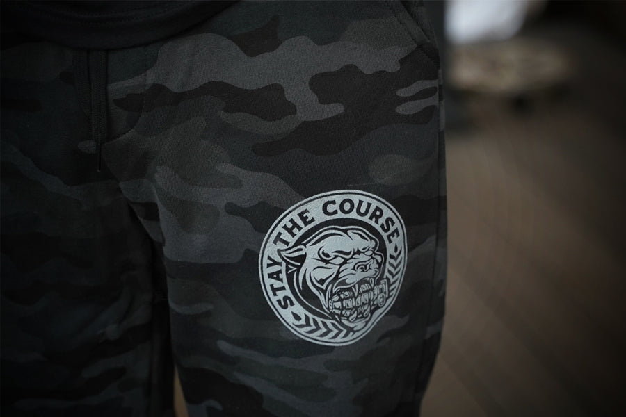 Camouflage pants with a gray logo on a blurred background