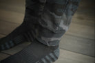 Camouflage pants cuff on a wooden floor