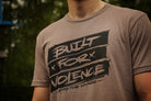 Person wearing a t-shirt with 'Built for Violence' text design.