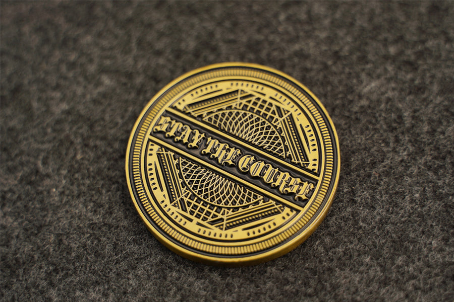 Antique brass coin with 'Stay the Course' text on a textured brown background