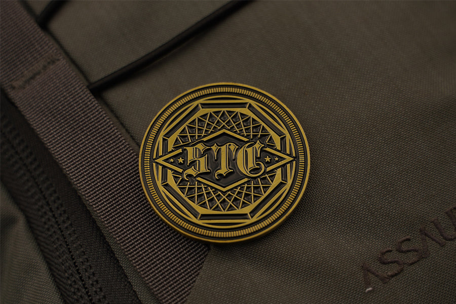 Close-up of antique brass emblem on a brown fabric surface