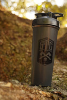 Black blender bottle against tree background