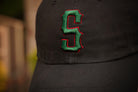 Black cap with a green and red 'S' logo on a blurred background