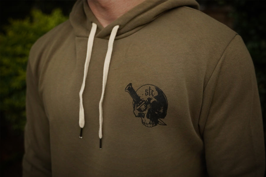 Military green hoodie with a black graphic design on the chest against a dark background