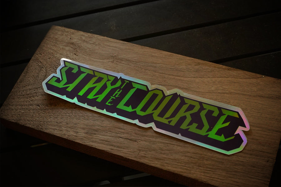 Holographic 'Stay the Course' sticker on a wooden surface