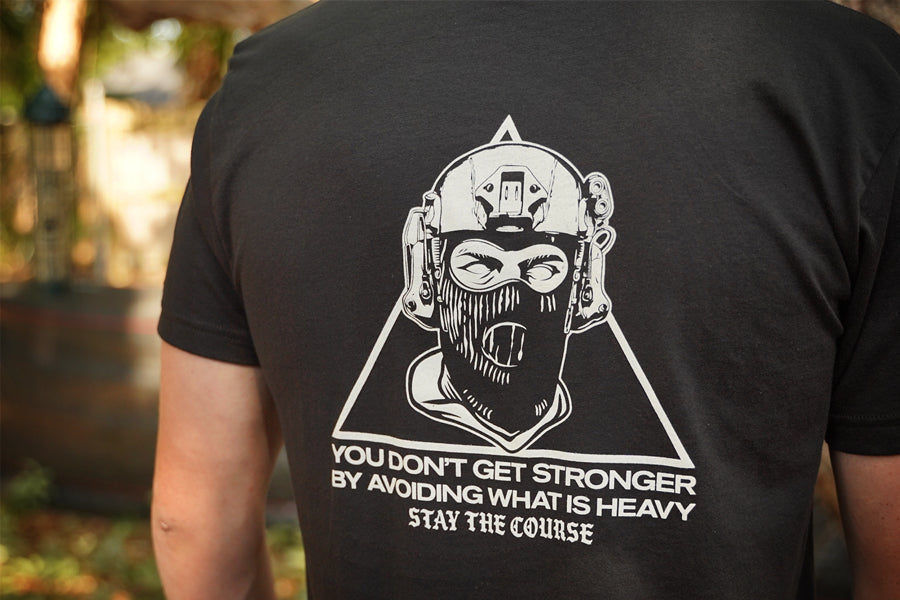 Black t-shirt with white graphic and text on the back, worn by a person.