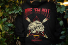 Black hoodie with red and bone graphic design featuring a skull and text 'Give 'em Hell' in front of green foliage.