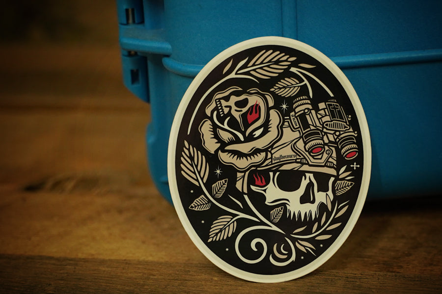 Decorative sticker with skull and rose design on a blue container