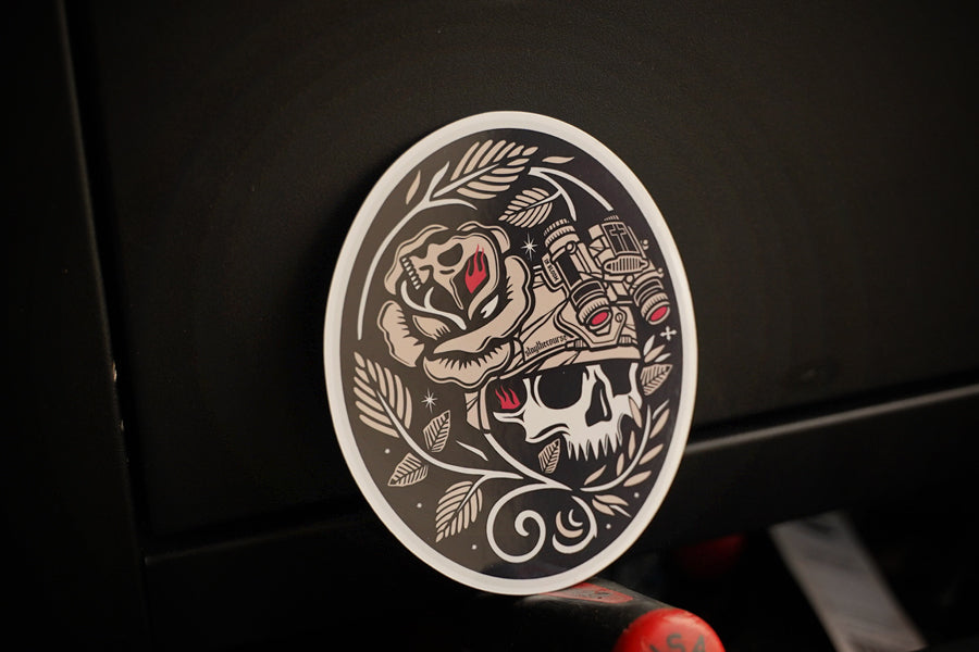Decorative sticker with skull and rose design on a dark background