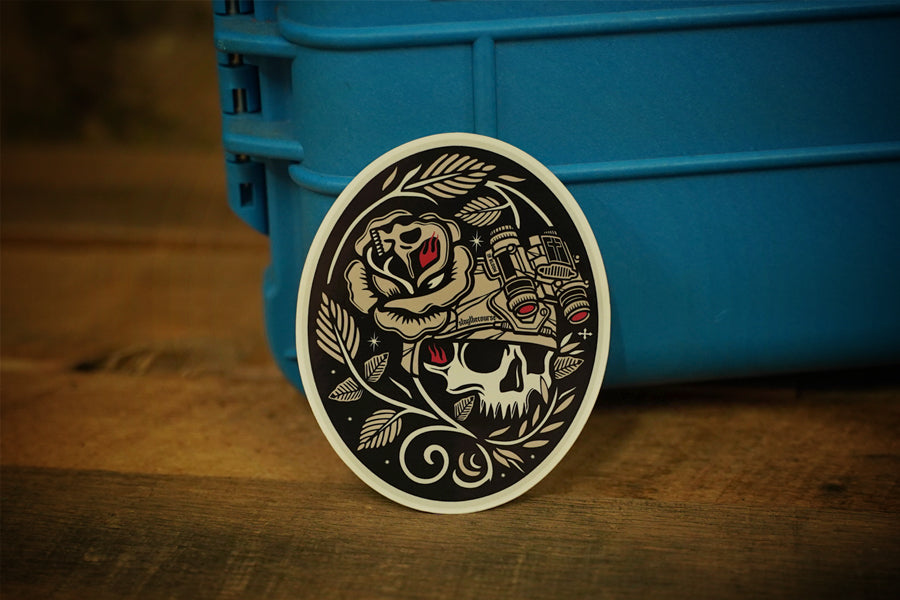 Decorative sticker with skull and rose design on a blue container