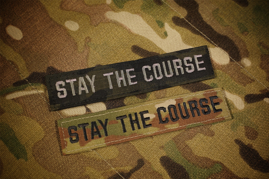 Two 'Stay the Course' patches on a camouflage background