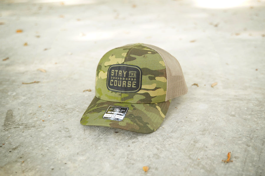Camouflage cap with text on concrete