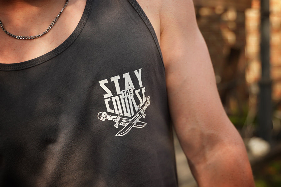 Person wearing a gray tank top with 'Stay the Course' graphic design.