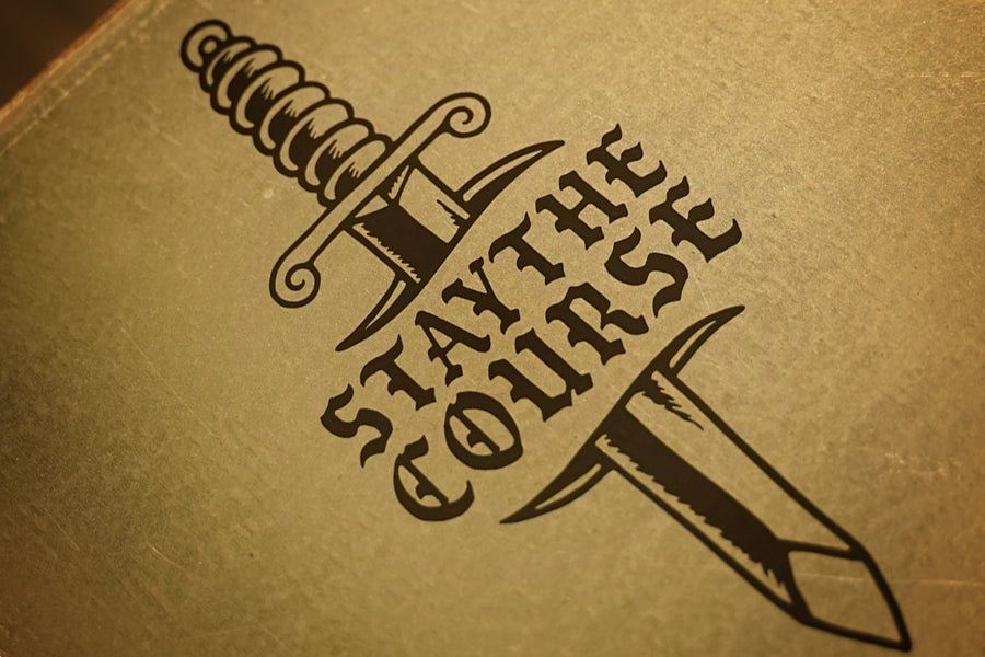 black vinyl decal of dagger and "stay the course" on metal cabinet