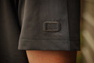 Close-up of a dark gray fabric with a logo on a blurred background