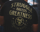 Black t-shirt with 'Struggle Breeds Greatness' text and graphic design on the back.