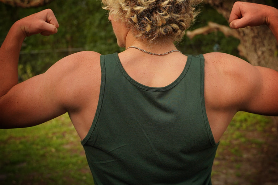 Person wearing a green tank top outdoors
