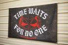 5x3 black camo flag with white and red design that says ice waits for no one, hanging on a metal siding building