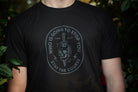 Person wearing a black t-shirt with a graphic design and text.