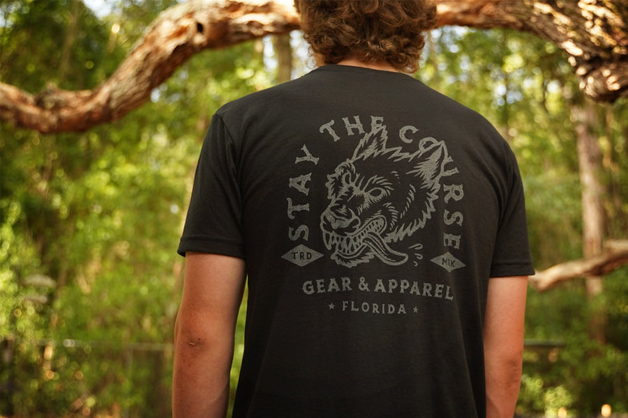 Person wearing a black t-shirt with gray print of wolfhound head and "stay the Course"