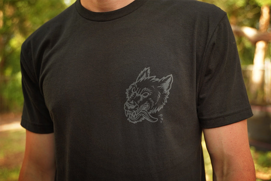 Person wearing a black t-shirt with gray print of wolfhound head 